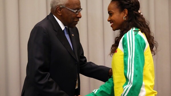 Lamine Diack (L), IAAF President greets Genzebe Dibaba of Ethiopia during a press conference prior to the IAAF World Indoor | Photo Credit: IAAF / Getty Images