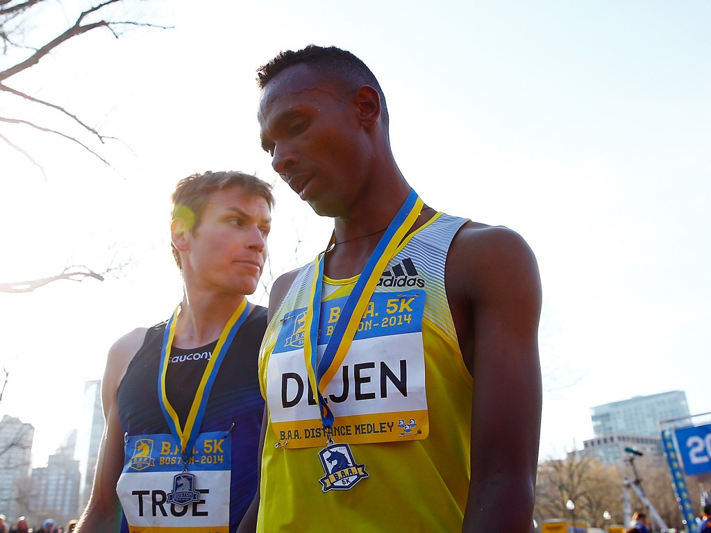 Dejen Gebremeskel of Ethiopia edged out Ben True (USA) for first place walk near the finish line of the 2014 B.A.A. 5K on April 19, 2014 in Boston, Massachusetts. (Photo by Jared Wickerham/Getty Images)
