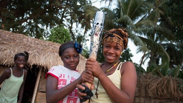 Two smiling girls hold the Queen’s Baton in Freetown, Sierra Leone, on Tuesday 31 December 2013 / Glasgow 2014 OC Flickr
