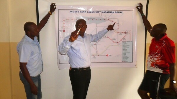 Yussuf Alli shows the Lagos Marathon route map to the media