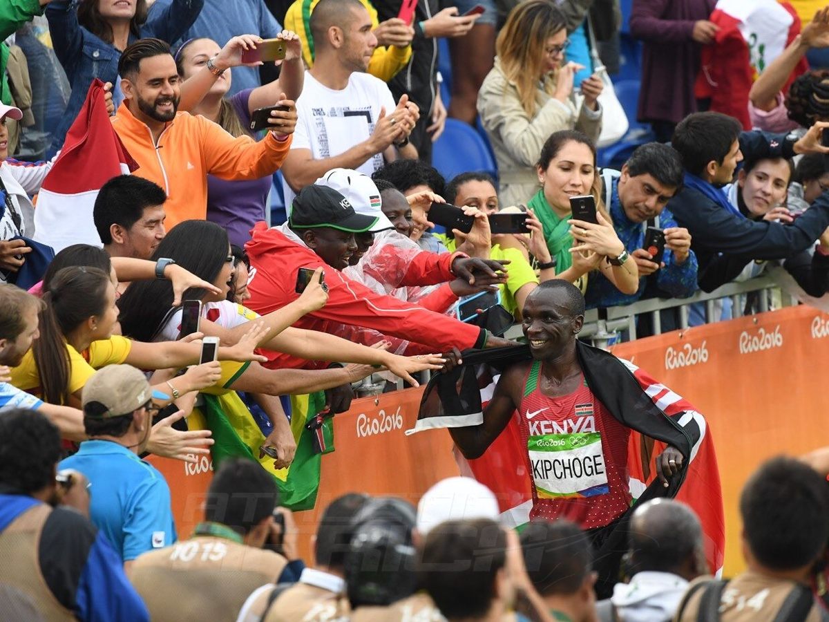 Kenya's Eliud Kipchoge with fans after he won the men's marathon gold on the final day of competition at the Rio 2016 Olympics in 2:08:44 / Photo Credit: Norman Katende