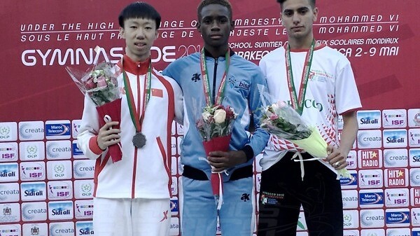 Botswana's Bernard Olesite (C) with Sheng Luo of China and Mehdi Sefrani of Morocco on the podium after the Boys 400m medal presentation at Gymnasiade 2018 in Marrakech / Photo Credit: Yomi Omogbeja