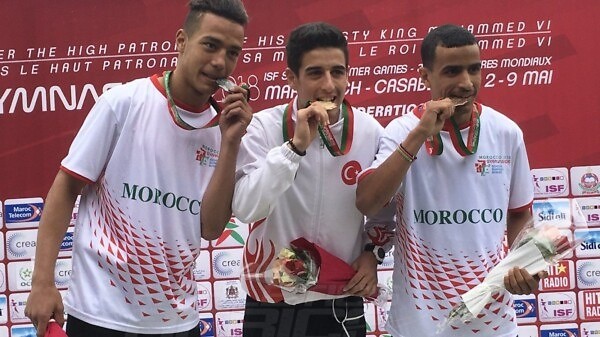 Turkey's Mehmet Celik (C) flanked by Moroccans Mohammed Aboutahiry and Yeva Podhorodetska on the podium after the Boys 800m medal presentation at Gymnasiade 2018 in Marrakech / Photo Credit: Yomi Omogbeja
