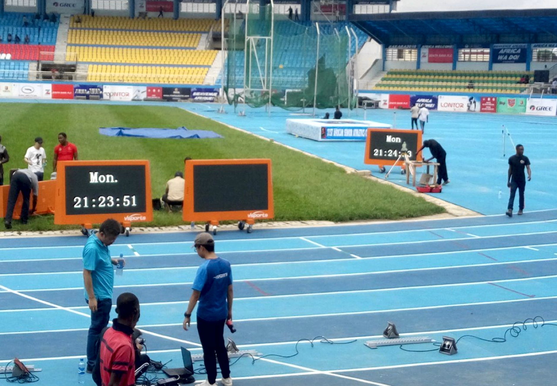 LOC contractors and officials set up the timing equipment at the Stephen Keshi stadium in Asaba on Monday 31 July / Photo credit: Naomi Peters for Athletics Africa