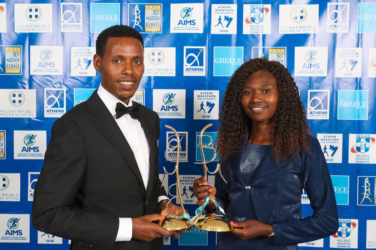 Lelisa Desisa and Ruth Chepngetich with their prizes / Photo credit: Victah Sailer / AMA