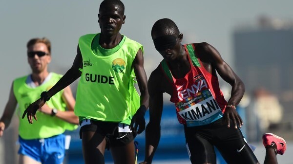 Samwel Kimani of Kenya and guide Boit James crosses the line to clinch gold in the Men's 5000m T11 final at Dubai 2019 World Para Athletics Championships. ⒸGetty Images