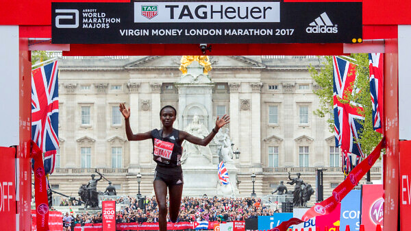 Mary Keitany KEN raises her arms as she crosses the finish line winning the elite women's race. The Virgin Money London Marathon, 23rd April 2017. credit: Roger Allen for Virgin Money London Marathon