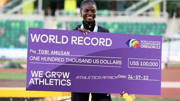 Gold medalist Tobi Amusan of Team Nigeria poses with a check for setting a world record in Women's 100m Hurdles on day ten of the World Athletics Championships Oregon22 at Hayward Field on July 24, 2022 in Eugene, Oregon. (Photo by Andy Lyons/Getty Images