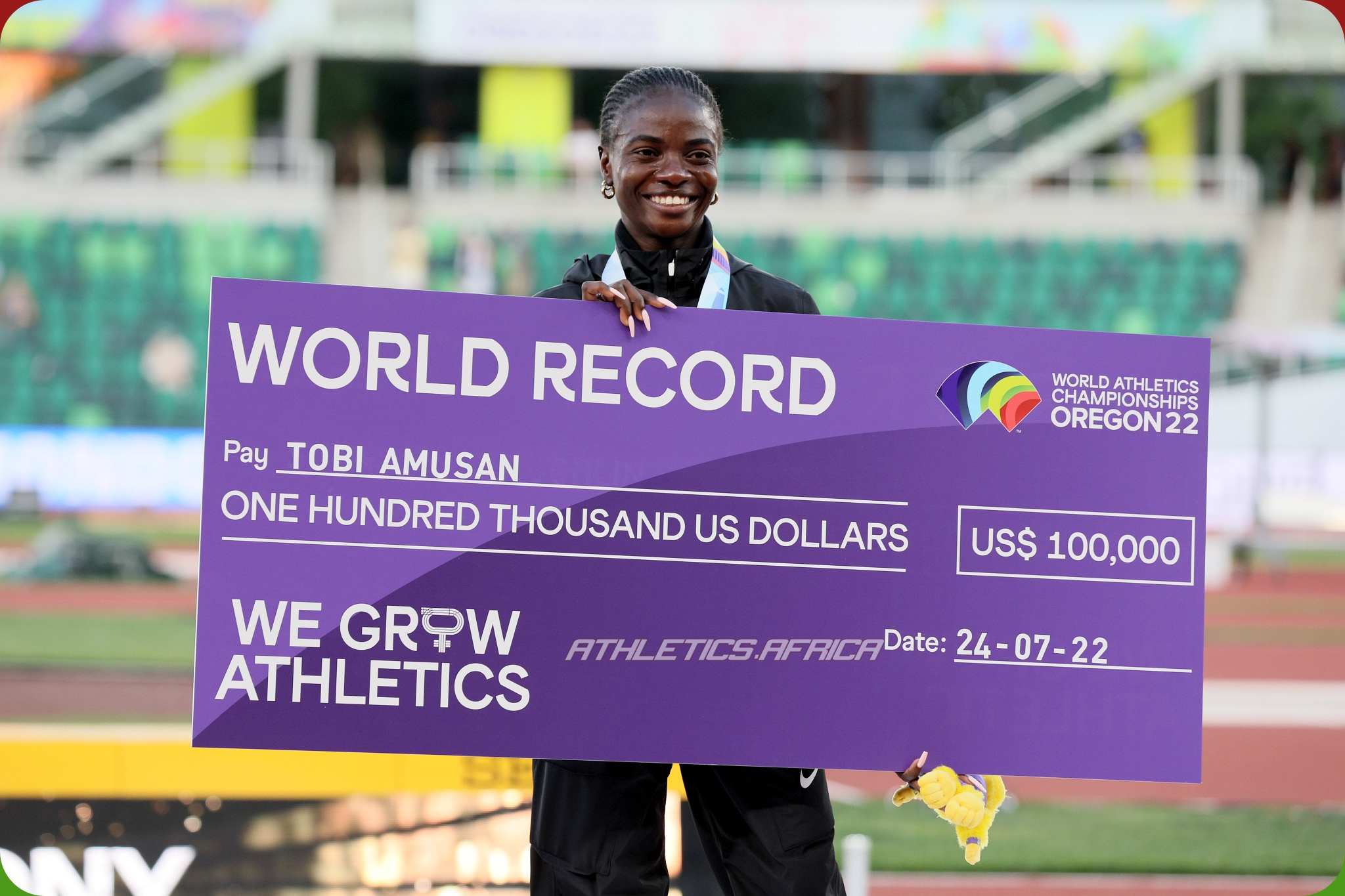 Gold medalist Tobi Amusan of Team Nigeria poses with a check for setting a world record in Women's 100m Hurdles on day ten of the World Athletics Championships Oregon22 at Hayward Field on July 24, 2022 in Eugene, Oregon. (Photo by Andy Lyons/Getty Images